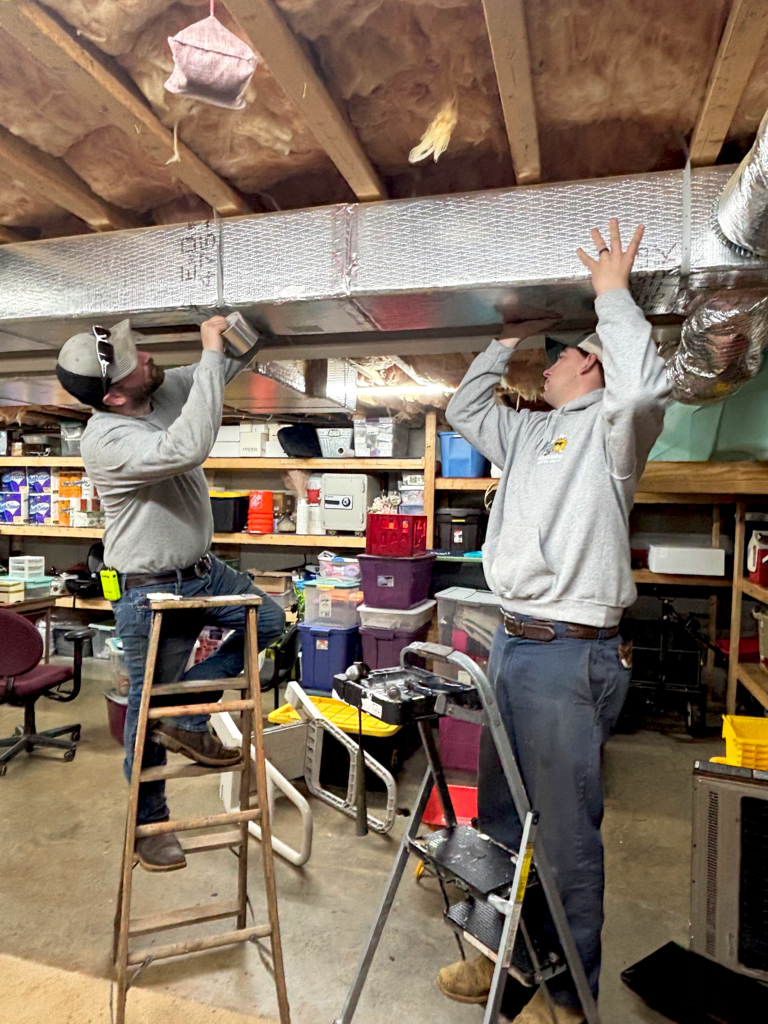 w and w mechanical heating and air technician installing a aircon indoors