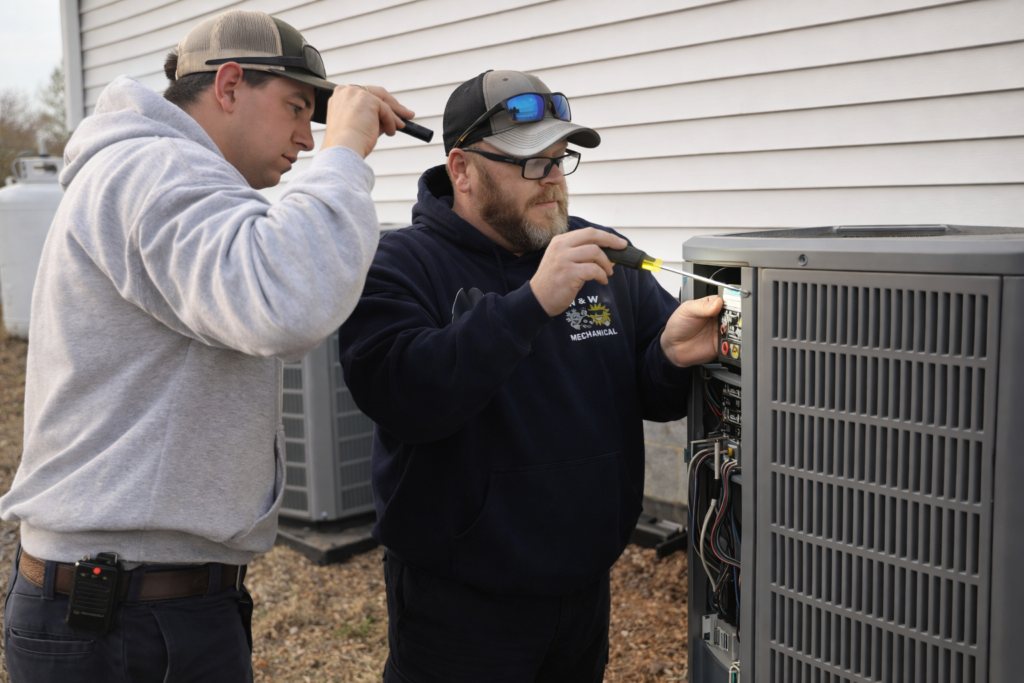 w and w mechanical heating and air technician maintaining an aircon